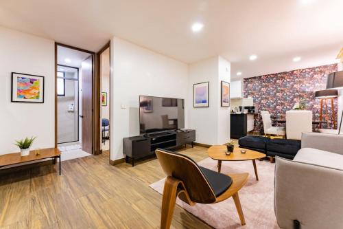 a living room with a couch and a table at Modern Apartment with Gym in La Condesa in Mexico City