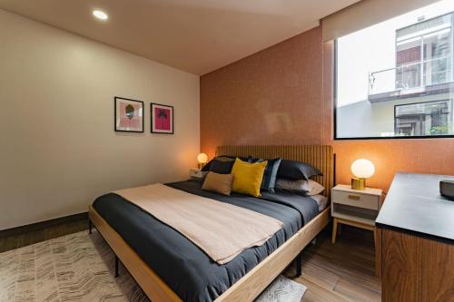 a bedroom with a large bed and a window at Modern Apartment with Gym in La Condesa in Mexico City