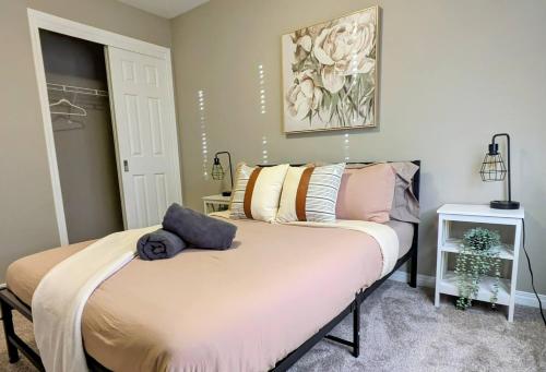 a bedroom with a bed with pillows on it at A Slice Of Heaven In Airdrie By Eagleswingshomes1 in Airdrie