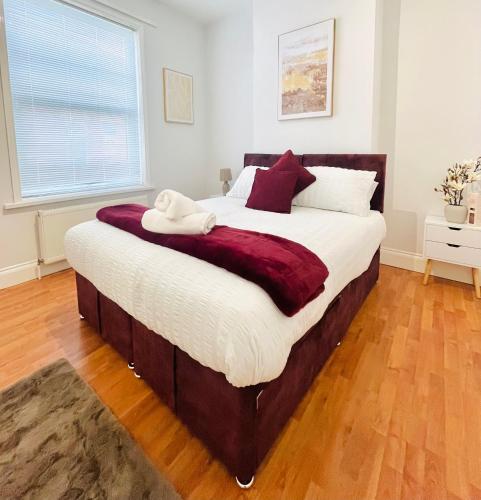 a bedroom with a large bed with white and red pillows at Fawcett House in Portsmouth