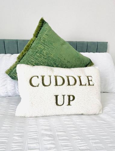 a pillow on a bed with the words guided up at Fawcett House in Portsmouth