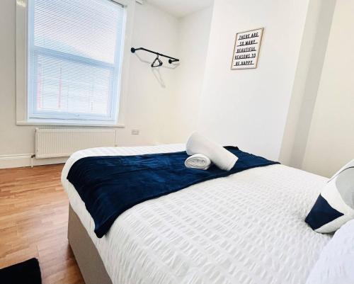 a bedroom with a large bed and a window at Fawcett House in Portsmouth