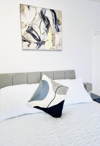 a bed with a black and white pillow on it at Fawcett House in Portsmouth