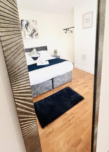 a bedroom with a bed and a mirror at Fawcett House in Portsmouth
