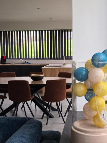 a living room with a table and some chairs at La maison d'Achille in Nassogne