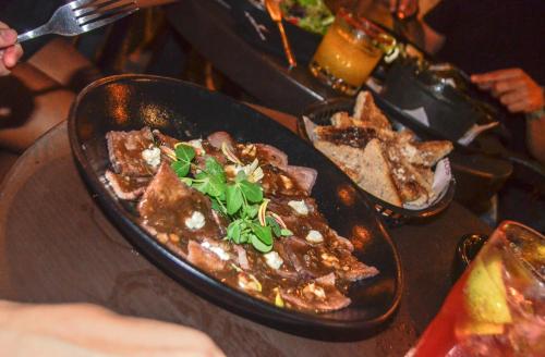 a table with two plates of food on a table at Casa Lucia Hotel Boutique in Mérida