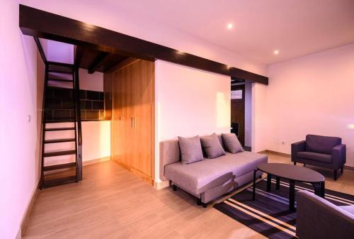 a living room with a couch and a loft bed at Finca con Piscina en Doniños in Ferrol