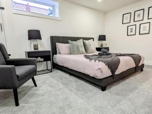 a bedroom with a bed and a chair at A Slice Of Heaven In Chestermere in Calgary