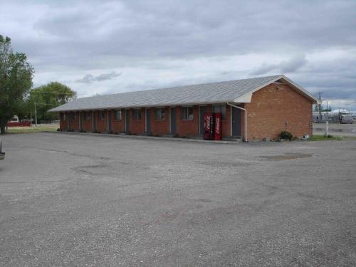 a red brick building with a large parking lot at Tops Motel in Burley