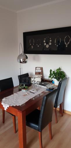 a dining room table with two chairs and a table at Village Marina in Olhão