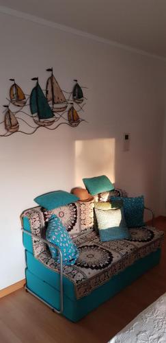 a room with a couch with pillows on it at Village Marina in Olhão