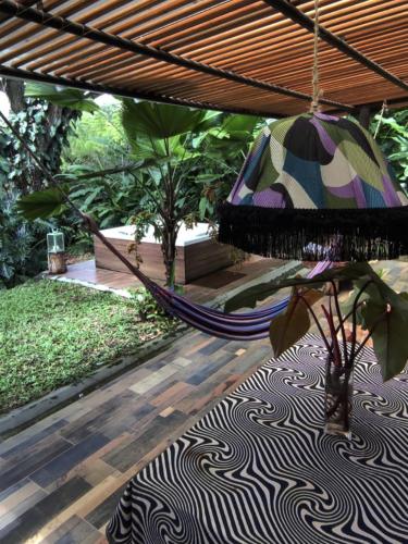 a hammock in a garden with a patio at Tierra Negra Suite in Pereira