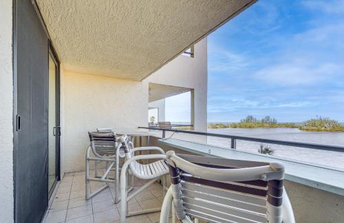a balcony with two chairs and a table at Scenic Balcony and Beach Access Hudson Condo in Hudson