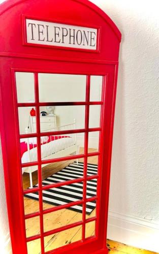 a red telephone booth sitting in a room at Taswell Road in Portsmouth
