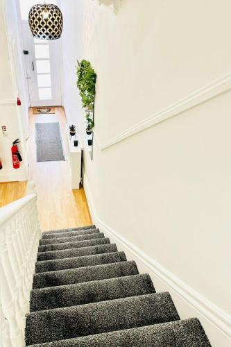 a staircase in a home with white walls at Taswell Road in Portsmouth