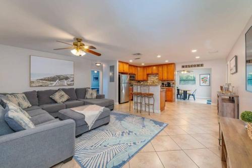 a living room with a couch and a kitchen at Ventur Tropical w Hot Tub Close to Beach in Deerfield Beach