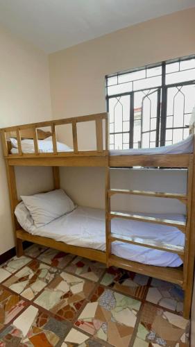 two bunk beds in a room with a floor at Maria Kulafu Lodging House Pier site- Santa Clara office 2nd Floor in Cagba