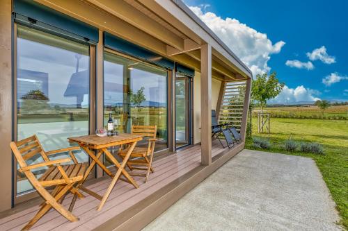 a wooden deck with a table and chairs on it at River View Suite Mlinar Private Beach - Happy Rentals in Metlika