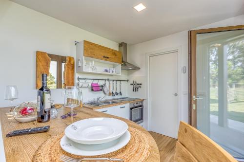 a kitchen with a table with white plates and wine glasses at River View Suite Mlinar Private Beach - Happy Rentals in Metlika
