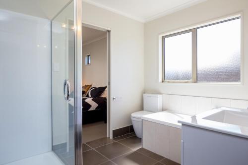 uma casa de banho com um WC, um lavatório e uma janela em 26 On Clearwater em Blenheim