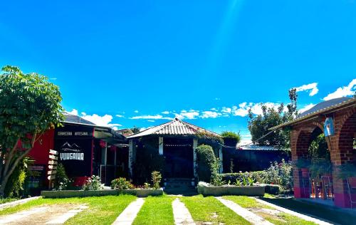a house with a front yard with a lawn at Alpamayo Casa Hotel - Restaurante in Yungay