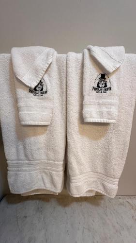 two white towels sitting on top of a counter at Phineas Swann Inn & Spa in Montgomery Center