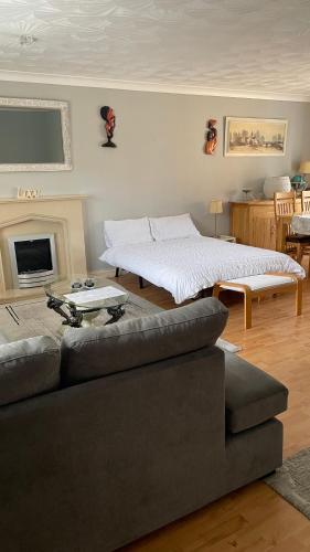 a living room with a couch and a bed at Serenity in Peterborough
