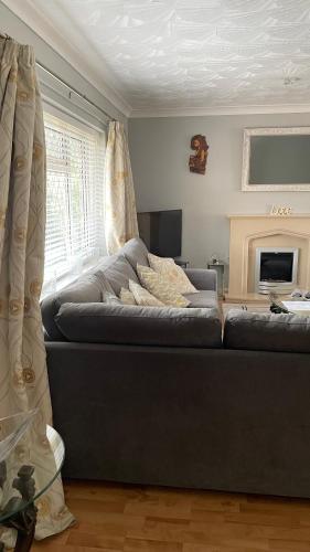 a living room with a couch and a fireplace at Serenity in Peterborough