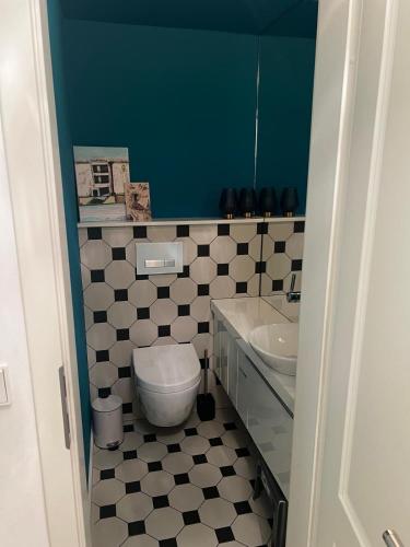 a bathroom with a toilet and a sink at DOM LIVING - LuxusHaus in Fulda