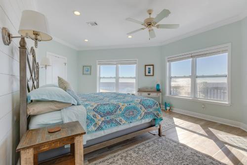 a bedroom with a bed and a ceiling fan at Ocean Springs Magnolia Beach House on Pvt Beach! in Ocean Springs