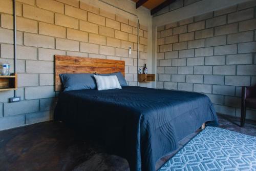 a bedroom with a bed in a brick wall at House Terravid in Ensenada
