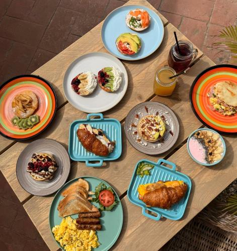 a table with plates of breakfast food on it at Arubiana Inn Hotel in Palm-Eagle Beach