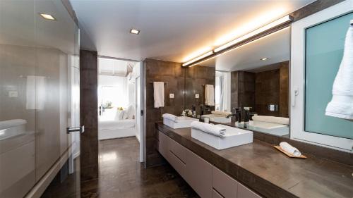 a bathroom with two sinks and a large mirror at Haven of peace villa in a perfect setting in Marigot