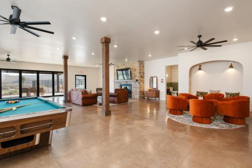 a living room with a pool table and couches at Hidden Springs RV Resort in Ivins
