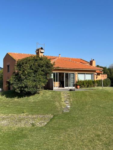 a house with a tree in front of it at Casa da Bonança Ofir in Fão