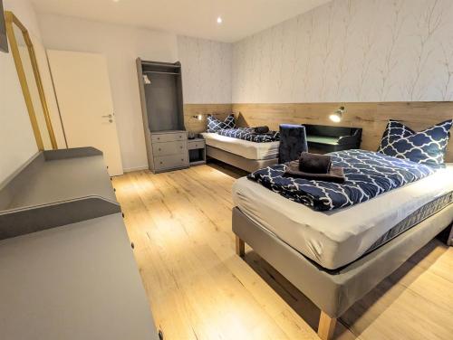 a bedroom with two beds and a tv in it at Apartmenthaus Bargteheide Apartment 1 in Bargteheide