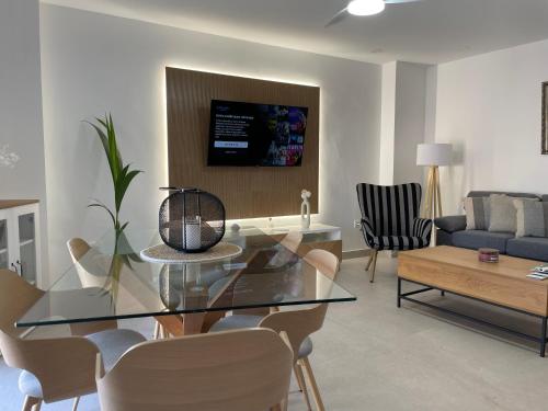 a living room with a glass table and chairs at Cabosun in El Cabo de Gata