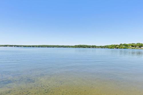 a large body of water with trees in the background at Chippewa Bluffs Resort Spacious Combined 4BR 4BA Cabins in Barryton