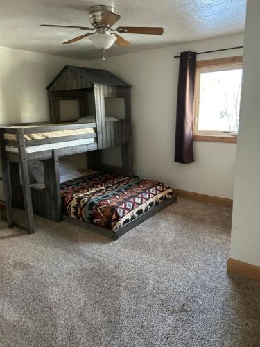 a bedroom with a bunk bed and a ceiling fan at Chinook Winds Lodge in Dubois