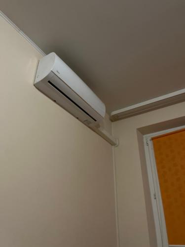 a ceiling light on a white wall in a room at Милая уютная квартирка in Visaginas