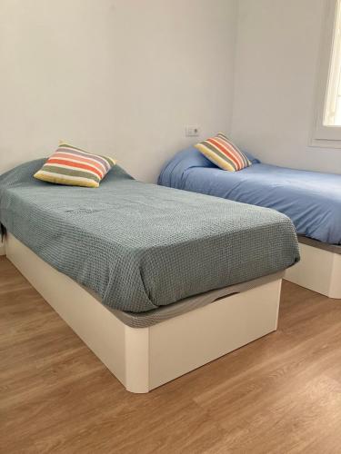 two twin beds in a room withthritisthritisthritisthritisthritisthritisccess at Descanso del GUERRERO in San Miguel de Fluviá