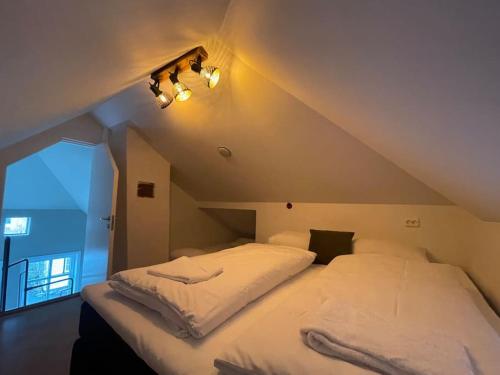 a large bed in a room with an attic at Nostalgic Nook 27 by Stavanger BnB in Stavanger