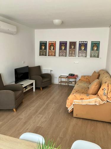 a living room with a bed and a couch at Descanso del GUERRERO in San Miguel de Fluviá
