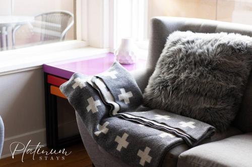 a pillow sitting on a chair next to a desk at Luxury On Webster Upscale 2br Close To Hospital in Wendouree