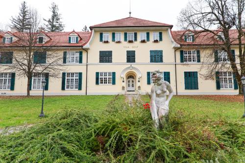 a statue in front of a large building at Apartments at Villa Golf in Rogaška Slatina