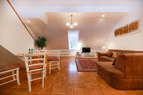 a living room with a table and a couch at Apartments at Villa Golf in Rogaška Slatina