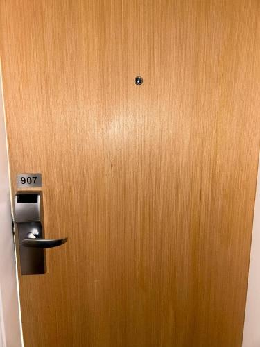 a wooden door with a sign on it at Hotel Biena Sena Madureira PqIbirapuera Com Garagem 907 in Sao Paulo