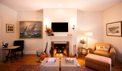 a living room with a couch and a fireplace at Hearthside Inn in Bar Harbor