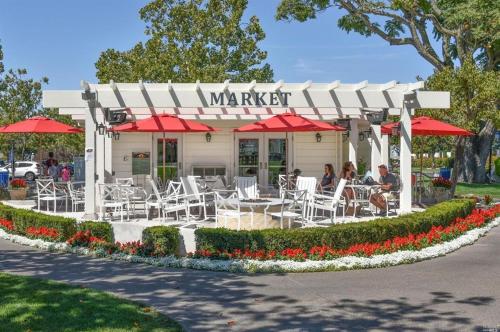a restaurant with tables and chairs and red umbrellas at Silverado Golf Course View Property in Napa