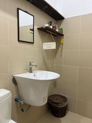 a bathroom with a sink and a toilet at Lone Traveler Beach View Room in Caridad